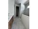 Bathroom featuring double vanity, marble floors, and a glass shower with a window at 7263 Kodiak Ln, Sarasota, FL 34240