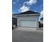 Detached two-car garage with white door and decorative exterior lighting at 7263 Kodiak Ln, Sarasota, FL 34240