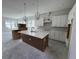 Bright new kitchen featuring an island, stainless steel appliances and white cabinets in a well lit room at 7263 Kodiak Ln, Sarasota, FL 34240
