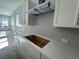 Modern kitchen featuring white cabinets, quartz countertops, and tiled backsplash at 7263 Kodiak Ln, Sarasota, FL 34240