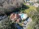 Aerial view of the property highlighting the swimming pool and surrounding green spaces and community buildings at 7807 Hardwick Dr # 115, New Port Richey, FL 34653