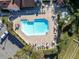 Overhead view of the community pool, showcasing sun loungers, tables, and surrounding landscape at 7807 Hardwick Dr # 115, New Port Richey, FL 34653
