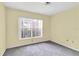 Bedroom with neutral carpet, a window providing natural light, and neutral-colored walls at 7807 Hardwick Dr # 115, New Port Richey, FL 34653