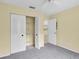 Bedroom closet with bifold doors and wire shelving for optimal storage at 7807 Hardwick Dr # 115, New Port Richey, FL 34653