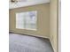 Bedroom with neutral carpet, a window providing natural light, and a closet at 7807 Hardwick Dr # 115, New Port Richey, FL 34653