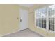 Bright entryway featuring neutral tile flooring, a window, and a white front door at 7807 Hardwick Dr # 115, New Port Richey, FL 34653