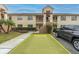 Apartment building with dedicated parking spot surrounded by green foliage, offering a suburban setting at 7807 Hardwick Dr # 115, New Port Richey, FL 34653