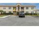Exterior view of the building showcasing a car parked outside the apartment complex at 7807 Hardwick Dr # 115, New Port Richey, FL 34653