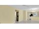 The living room area has tile floors that flow into a dining area and an area for a stackable washer and dryer at 7807 Hardwick Dr # 115, New Port Richey, FL 34653