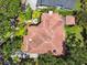 Aerial view of a home featuring a red tile roof, lush landscaping, and a private backyard with a patio at 808 Idlewood Ave, Tampa, FL 33609