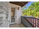 Charming balcony with terra cotta tile and a wrought iron railing overlooks lush greenery at 808 Idlewood Ave, Tampa, FL 33609