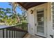 Charming balcony with terra cotta tile and a wrought iron railing overlooks lush greenery at 808 Idlewood Ave, Tampa, FL 33609