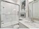 Bathroom featuring a bathtub with glass sliding door, toilet, sink with marble countertop at 808 Idlewood Ave, Tampa, FL 33609