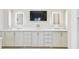Bathroom vanity featuring double sinks, white cabinetry, marble countertops, and LED mirrors at 808 Idlewood Ave, Tampa, FL 33609