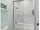 Bathroom featuring a glass shower, toilet, and tiled walls at 808 Idlewood Ave, Tampa, FL 33609