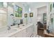 Bathroom featuring double sinks with marble countertops, black and white flooring, and an adjacent bedroom at 808 Idlewood Ave, Tampa, FL 33609