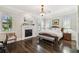 Traditional bedroom with hardwood floors, fireplace, and bench at the foot of the bed at 808 Idlewood Ave, Tampa, FL 33609