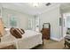 Bright bedroom with a queen-sized bed, soft carpet, and view of an ensuite bathroom at 808 Idlewood Ave, Tampa, FL 33609