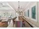 Bright, spacious dining room with a large table, elegant chandelier, and beautiful hardwood floors with area rug at 808 Idlewood Ave, Tampa, FL 33609