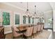 Dining room with an extended wooden table, seating for ten, and plantation shutters for natural light control at 808 Idlewood Ave, Tampa, FL 33609