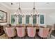 Formal dining room with large table, decorative lighting, and windows providing natural light at 808 Idlewood Ave, Tampa, FL 33609