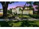 Beautiful two-story home with a well-manicured lawn, mature trees, and elegant architectural details at dusk at 808 Idlewood Ave, Tampa, FL 33609