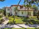 Exterior view of a light-colored home with a tile roof and palm trees in the front yard at 808 Idlewood Ave, Tampa, FL 33609