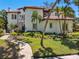 Exterior view of a two-story home with a tile roof and mature landscaping at 808 Idlewood Ave, Tampa, FL 33609