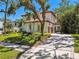 Exterior view of a two-story house featuring a tile roof and a spacious driveway at 808 Idlewood Ave, Tampa, FL 33609