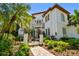 Elegant two-story home with a water fountain, wrought iron gate, and beautifully landscaped front yard at 808 Idlewood Ave, Tampa, FL 33609