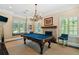 Entertainment room with a pool table, fireplace, window seat, and ample natural light at 808 Idlewood Ave, Tampa, FL 33609