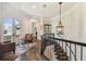Second-floor hallway with dark wood floors, iron railings, and seating area with balcony access at 808 Idlewood Ave, Tampa, FL 33609