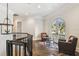 Upstairs hallway with dark wood floors and arched double doors to a balcony with outdoor seating at 808 Idlewood Ave, Tampa, FL 33609