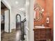 Warm hallway view features a staircase and ornate powder room with a decorative mirror and sink at 808 Idlewood Ave, Tampa, FL 33609