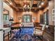 Sophisticated home office with wood-paneled walls, custom built-ins, and a comfortable seating area at 808 Idlewood Ave, Tampa, FL 33609