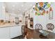Modern kitchen featuring stainless steel appliances, white cabinets, and a decorative, colorful chandelier at 808 Idlewood Ave, Tampa, FL 33609