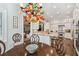 Open-concept kitchen with stainless steel appliances, white cabinetry, and colorful chandelier at 808 Idlewood Ave, Tampa, FL 33609