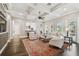 Bright living room with coffered ceilings, hardwood floors, fireplace, and large windows at 808 Idlewood Ave, Tampa, FL 33609