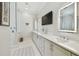 Bright bathroom features white cabinets, a large mirror, and a glass-enclosed shower at 808 Idlewood Ave, Tampa, FL 33609