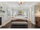 Spacious bedroom features wood floors, large bed, fireplace, and natural light from the windows at 808 Idlewood Ave, Tampa, FL 33609