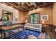 Elegant office with coffered ceiling, wood paneling, shutters, desk and blue rug at 808 Idlewood Ave, Tampa, FL 33609