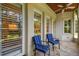 A screened patio featuring two chairs and stone floors at 808 Idlewood Ave, Tampa, FL 33609