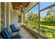 A covered patio with blue striped chairs, stone floors, and a view of tropical landscaping at 808 Idlewood Ave, Tampa, FL 33609
