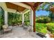 A covered patio with wood ceiling, fan, and cushioned seating at 808 Idlewood Ave, Tampa, FL 33609