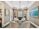Cozy sitting room with elegant furnishings, a decorative chandelier, and natural light at 808 Idlewood Ave, Tampa, FL 33609