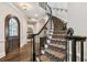 Elegant staircase with wrought iron railings, hardwood steps, and custom runner at 808 Idlewood Ave, Tampa, FL 33609