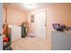 Bright laundry room with tile floors, washer, dryer, and water heater at 8371 55Th N St, Pinellas Park, FL 33781