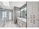 Bathroom featuring stone accent wall, white cabinetry, and glass enclosed shower at 8607 Cranes Roost Dr, New Port Richey, FL 34654