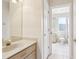 Bathroom view from hallway featuring a vanity and neutral tile at 10211 Quails Landing Ave, Tampa, FL 33647