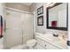 Bathroom featuring a glass shower, toilet and a vanity with mirror and artwork at 10211 Quails Landing Ave, Tampa, FL 33647